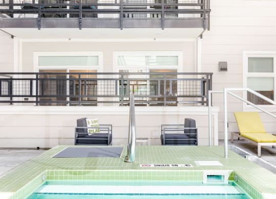 a view of the pool and deck from the hot tub