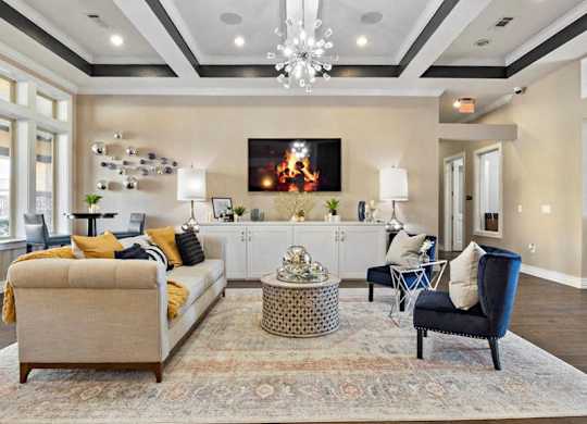 A living room with a large couch, a chair, and a coffee table.