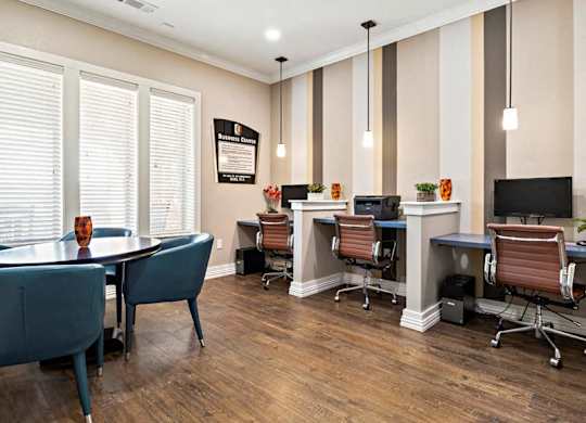 A room with a desk and chairs with a sign on the wall.