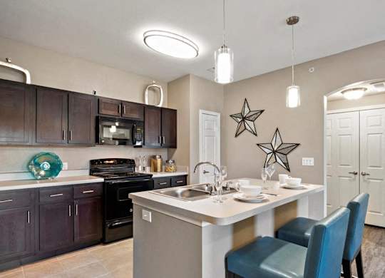 A kitchen with a table and chairs set for two.