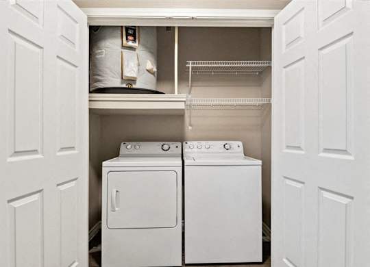 A white washing machine and dryer in a small laundry room.