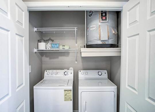 A small laundry room with a washer and dryer.