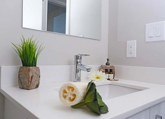a white bathroom with a sink and a mirror
