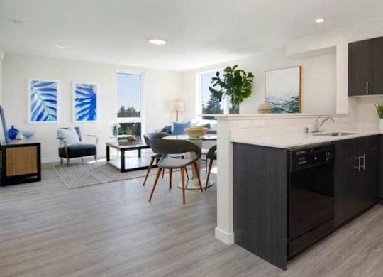 Kitchen Unit with dark cabinetry, efficient appliances, and plank flooring at Arabella Apartment Homes, Shoreline