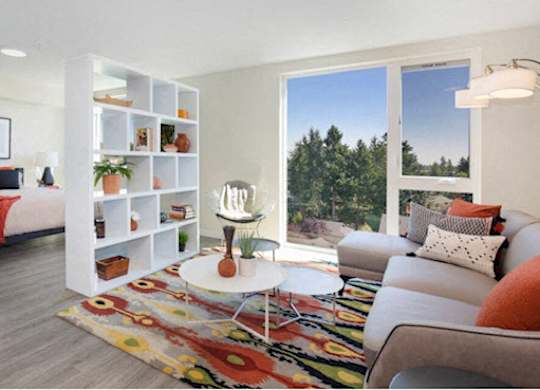 Studio Apartment with Living Room and Bedroom View with White Bookshelf separating and floor-to-ceiling windows at Arabella Apartment Homes, Shoreline