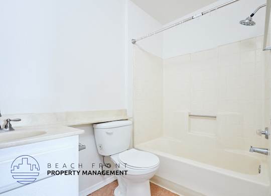 A white toilet sits next to a sink in a bathroom.