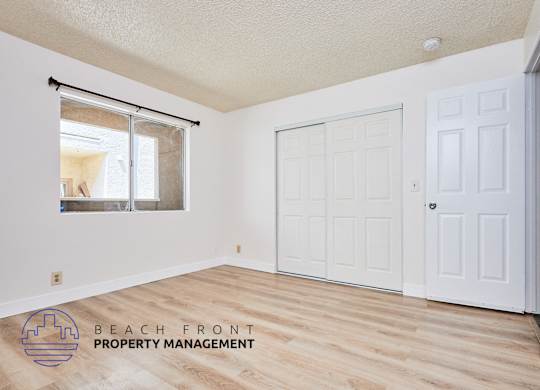A room with a sliding glass door and a white door.