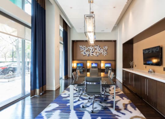 a room with a table and chairs and a large window at The Millennium, Arlington