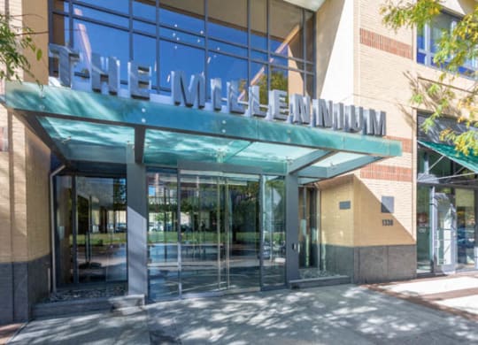 a building with a large glass door and a green awning at The Millennium, Arlington