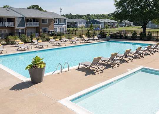 outdoor swimming pool and jacuzzi with lounge chairs