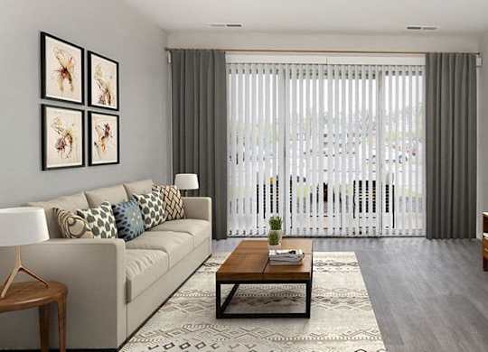 apartment living room with couch, area rug and coffee table with sliding door leading out to balcony