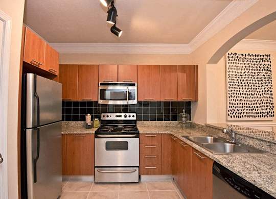 a kitchen with a stove refrigerator and a sink