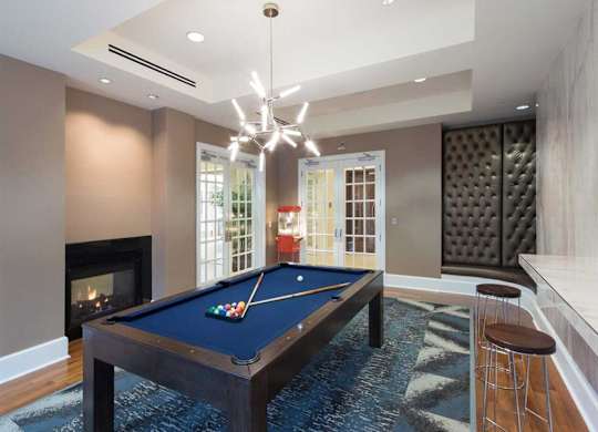 a pool table in a living room with a fireplace