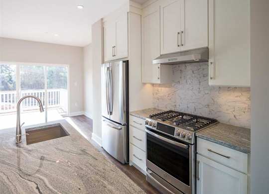 A kitchen with a countertop and stainless steel appliances at City Center Townes