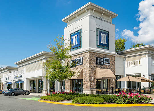 an exterior view of a building with cars parked outside