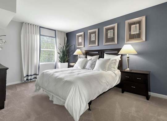 bedroom with blue walls and a white bed