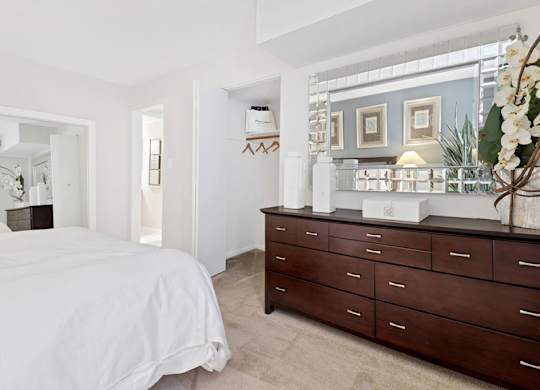a bedroom with a bed and a dresser