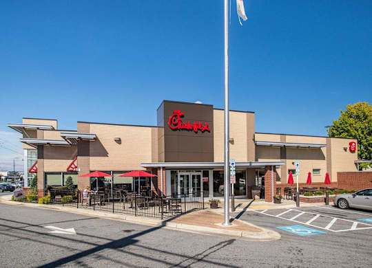 the facade of a grocery store with a flag in front