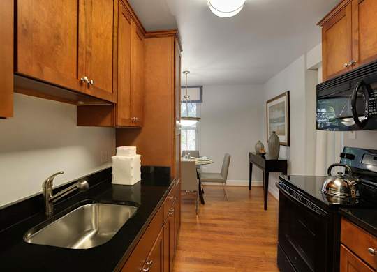 a kitchen and living room with a sink and a microwave