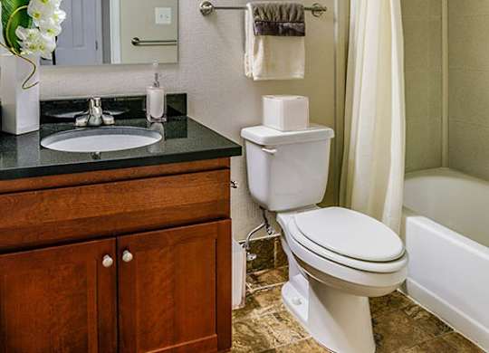 a bathroom with a toilet and a sink and a mirror
