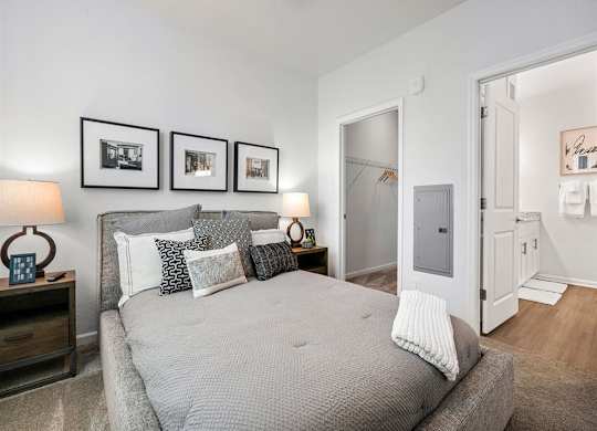 a bedroom with a bed and some pictures on the wall
