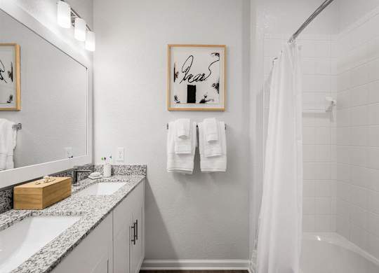 a bathroom with a shower and a sink and a mirror
