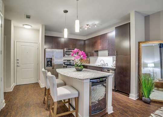A kitchen with a white countertop and stainless steel appliances.