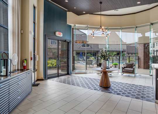 A modern lobby with a wooden table and chairs.
