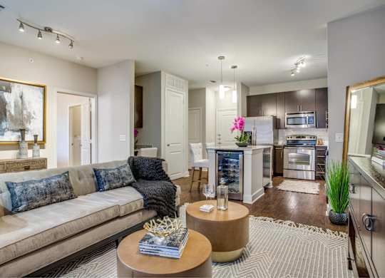 A modern living room with a beige couch and a coffee table.