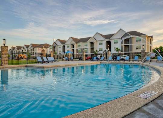A large swimming pool in front of a residential building at Mode at Melbourne, LLC Apartments, Melbourne, FL, 32901