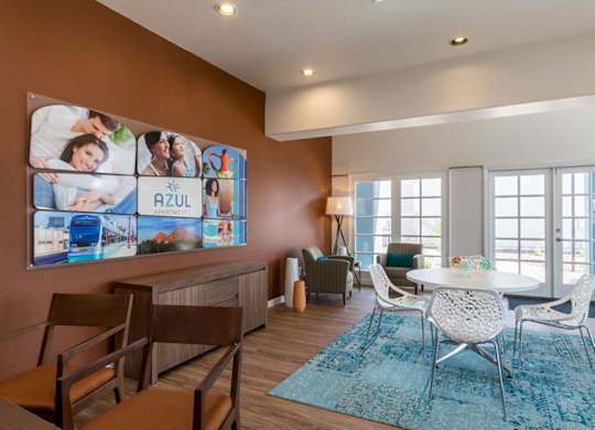 A living room with a large Azul poster on the wall.