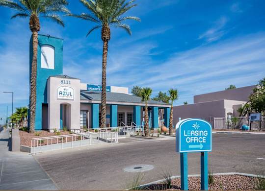 A blue and white building with a sign that says