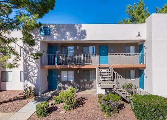 A modern apartment building with blue doors and windows.