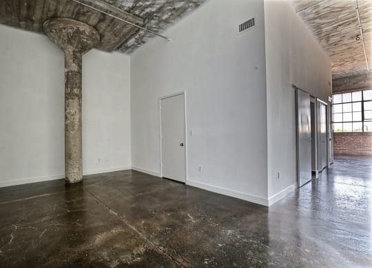 an empty room with a column in the middle of it