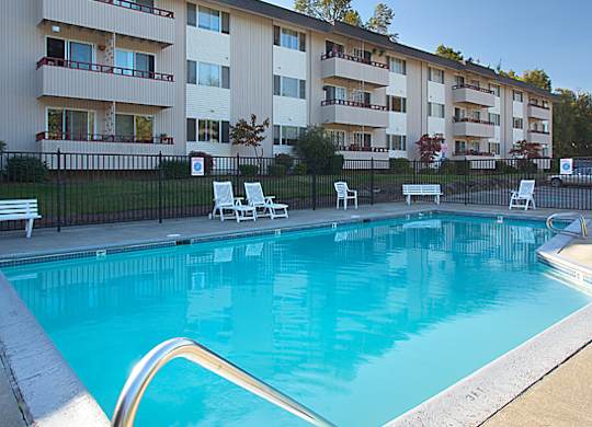 A swimming pool in front of apartment buildings.