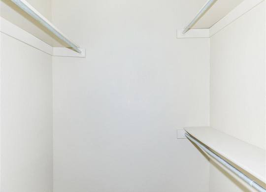 Empty white shelves in a room.