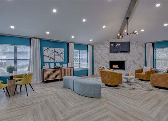 A living room with a grey sofa, yellow chairs, and a fireplace.