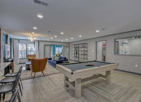 A room with a pool table and a chair.