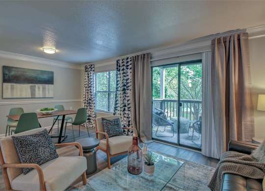 A living room with a glass table and chairs.