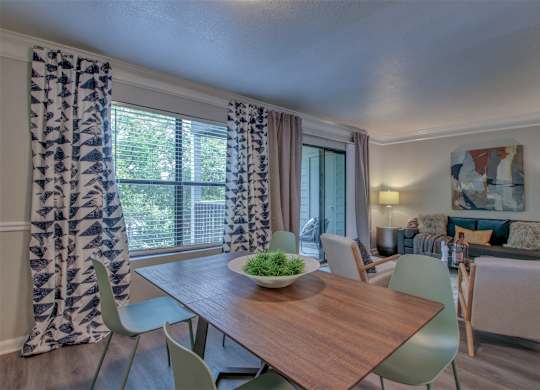 A dining room with a wooden table and chairs.