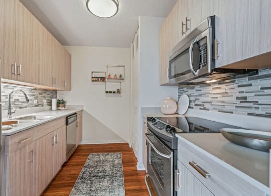 Galley kitchen with light cabinets and stainless steel appliances at Kingsbury Plaza in River North Chicago at Kingsbury Plaza, Chicago, 60654