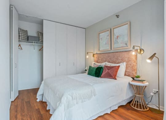 Bedroom with closet and Brazilian cherry wide plank floors at Kingsbury Plaza apartments at Kingsbury Plaza, Chicago, Illinois