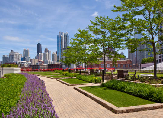 Green lawn terrace area with walkway, trees, tables and chairs at Kingsbury Plaza, Chicago, Illinois