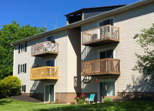 the back of a white house with two balconies at Oakwood Apartments, Florence, KY