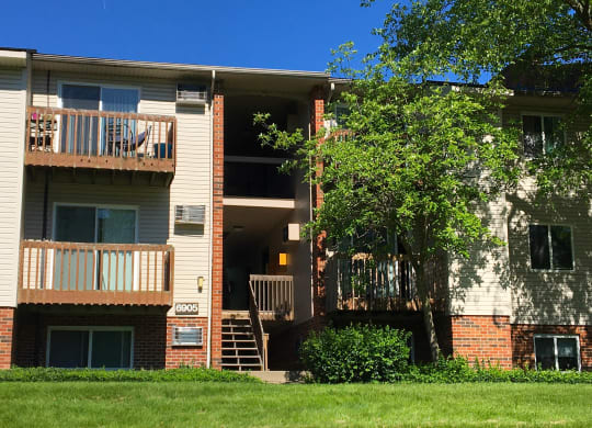 a view of an apartment building with stairs and a tree at Oakwood Apartments, Florence, Kentucky