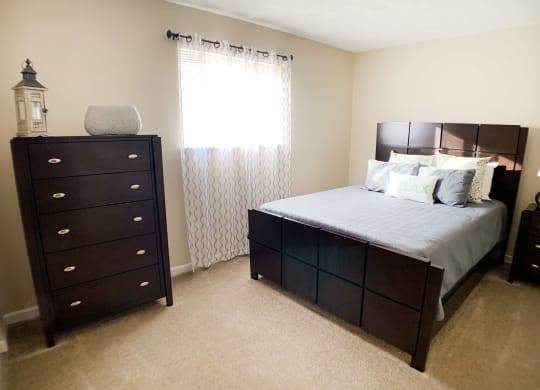 Bed and lamp at Oakwood Apartments, Florence, KY, 41042