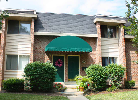 the front of a house with a green awning at Wentworth Estates Apartments, Kentucky