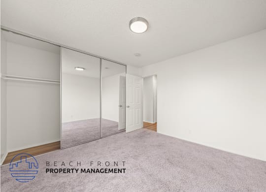 A room with a carpeted floor and a sliding door.