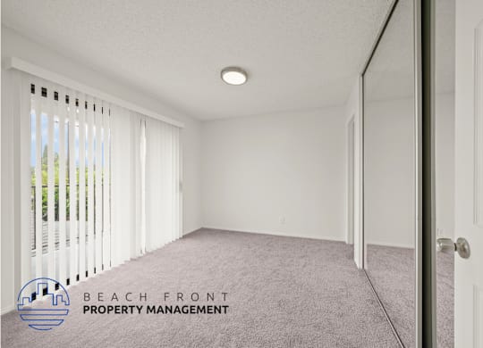 A room with a carpet floor and a door on the right side.