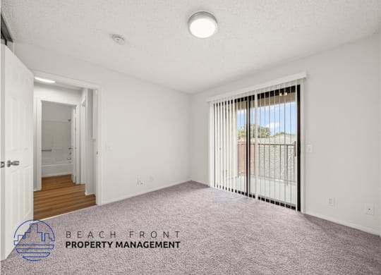 A spacious room with a view of the outside through the window.